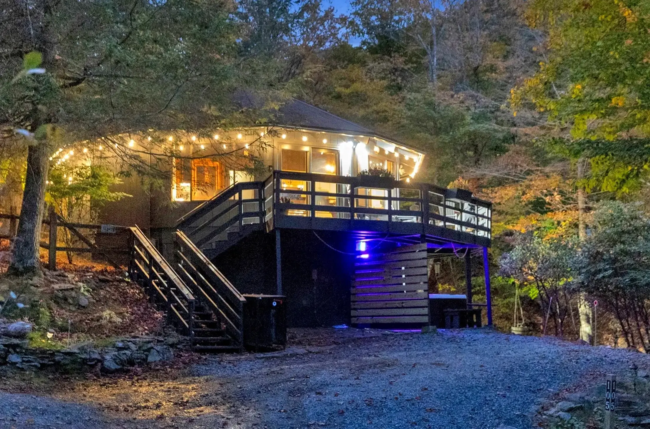 Cozy forest cabin illuminated at night.
